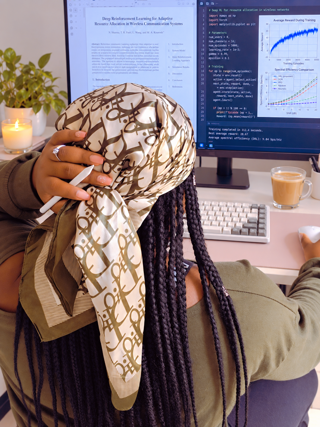 Vitoria working at a research desk on AI for wireless communications